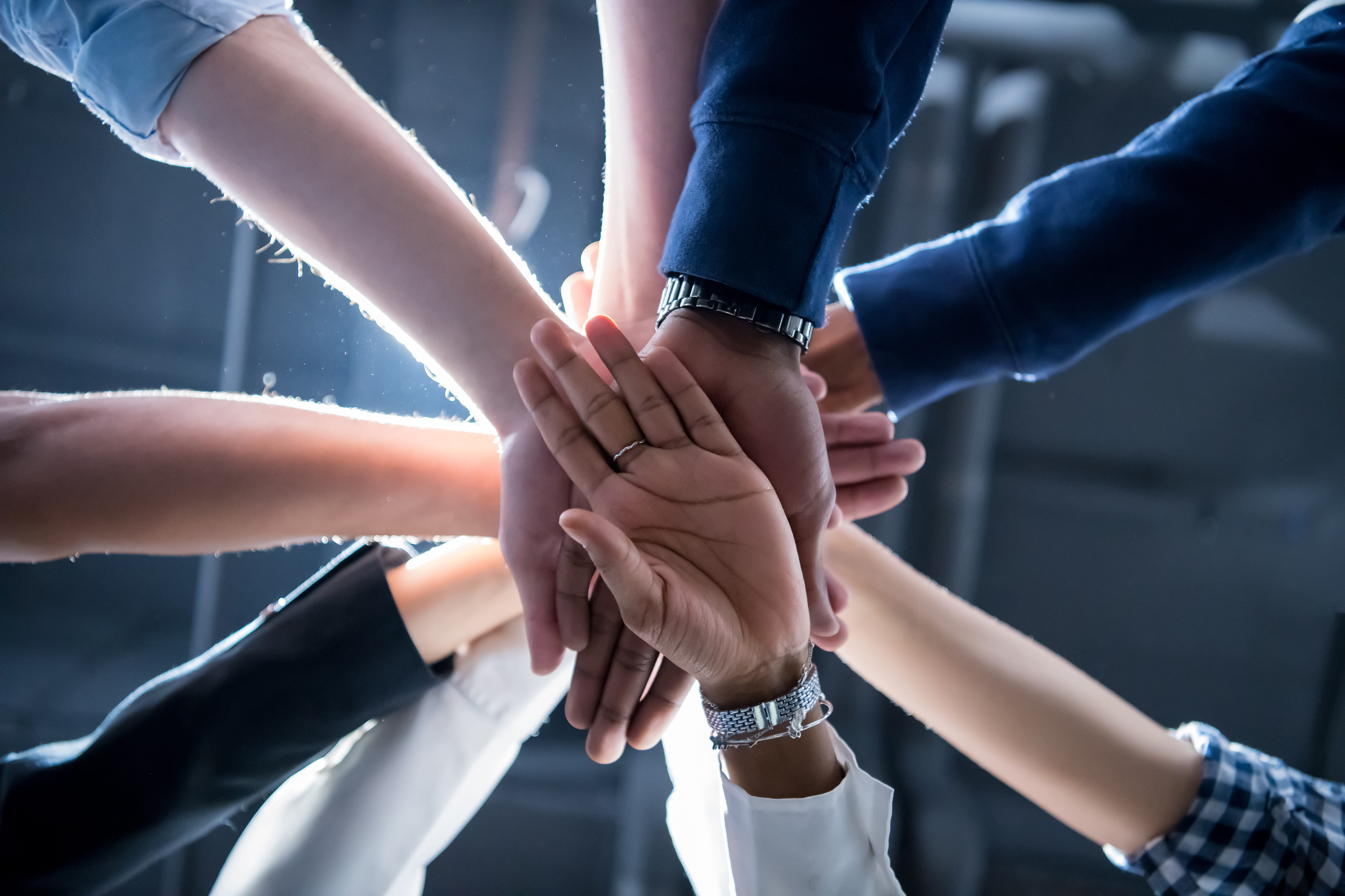 hands stacked in a team huddle